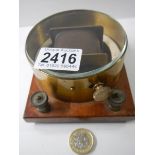 A horizontal differential galvanometer, brass cased on mahogany base, circa 1920.