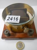 A horizontal differential galvanometer, brass cased on mahogany base, circa 1920.