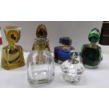Four coloured perfume bottles and two clear glass bottles.