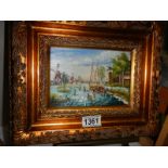 A gilt framed oil on board rural scene with windmills and fishing boats, 30 x 25 cm.