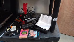 Atari CX 2600 game console with power lead, controllers and an array of game cartridges including