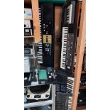 A Roland ''sound canvas'' 3 Yamaha and a Casio keyboard with stand