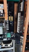 A Roland ''sound canvas'' 3 Yamaha and a Casio keyboard with stand