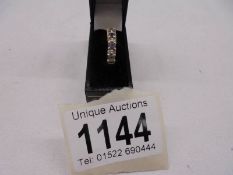 A tanzanite and diamond set ring hallmarked 18ct, Birmingham 2005, size L, 4.2 grams.
