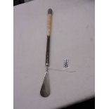 A good shoe horn with bone and silver handle.