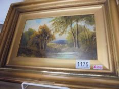 A gilt framed oil on board rural scene, signed but indistinct.