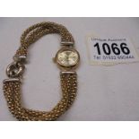 A 9ct gold ladies wrist watch on a 9ct gold bracelet, total weight 26.5 gram.