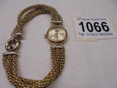 A 9ct gold ladies wrist watch on a 9ct gold bracelet, total weight 26.5 gram.