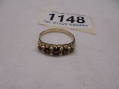 A Vintage garnet set five stone ring in gold, size O half, 1.9 grams.