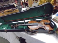 An old violin and bow in case.