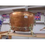 A brass and copper cauldron with lion head handles and lion paw feet. COLLECT ONLY.