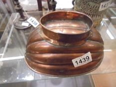 A Victorian copper jelly mould on footed base.
