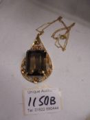 An 18c gold pendant set large stone (possibly smoky quartz) and a 750 gold chain.