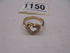 A diamond ring fashioned as a heart in gold, size O, 2.8 grams.