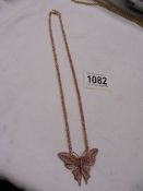 A 9ct rose gold necklace in the form of a butterfly, 11 grams.