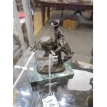 A bronze figure of a Rodeo Cowboy on a horse, base 9 x 5 cm, total height 12 cm.