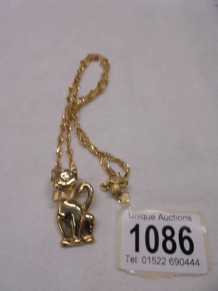 A 9ct gold cat pendant on a 9ct gold chain, 10.5 grams.