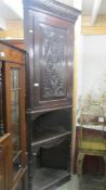 A carved corner cupboard on stand, COLLECT ONLY.