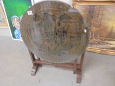 A heavily carved oriental tip top table with glass top. COLLECT ONLY.