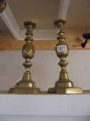 A pair of Victorian 'King of Diamonds' brass candlesticks.