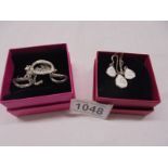 Two good quality silver pendants with matching earrings.