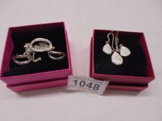 Two good quality silver pendants with matching earrings.
