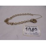 A 9ct gold wrist chain with padlock and safety chain. 7.6 grams.