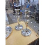 A pair of silver plate candlesticks.