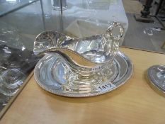 A silver plate gravy boat on tray.