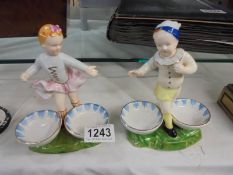 A pair of continental porcelain boy and girl figures.