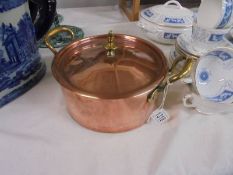 A good quality copper pan with brass knob and handles.