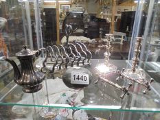 A silver plate toast rack, candlesticks, coffee pots, knife rests and snuff bottle.