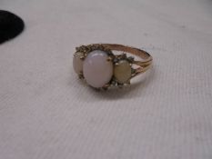 A 9ct gold ring set three opals, size U, 2.9 grams.