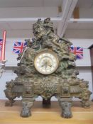 A heavy metal clock surmounted horse and rider. COLLECT ONLY.