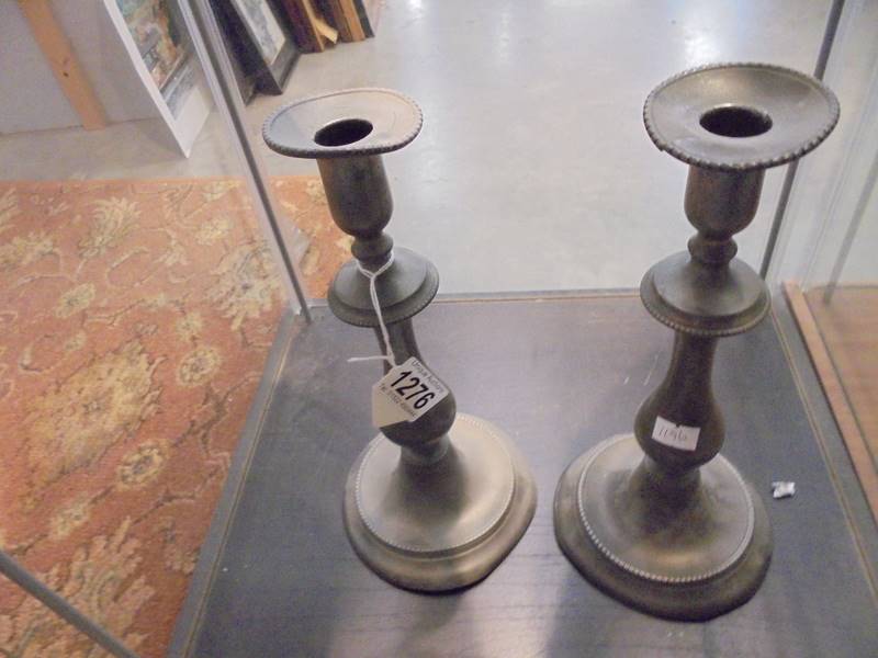 A pair of old pewter candlesticks, a/f.