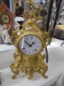 An ornate French mantel clock, a/f missing glass.