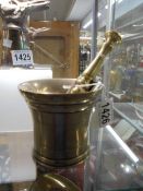 A brass pestle and mortar.