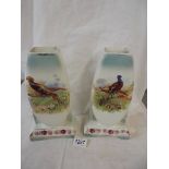 A pair of ceramic cases hand painted with pheasants.