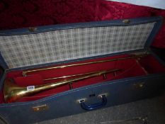 A cased trombone. COLLECT ONLY.