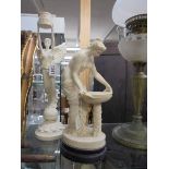 An Angel candlestick and a Grecian style figure.