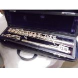 A cased silver plated flute by Trever James, London.