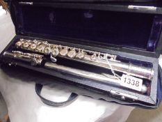 A cased silver plated flute by Trever James, London.