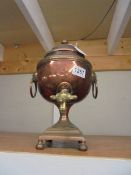 A Victorian copper samovar with brass tap.