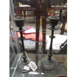 A pair of bronze candlesticks.