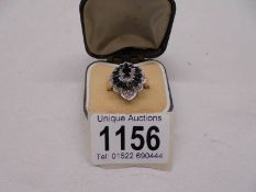 A marquise cut sapphire and diamond ring dated Birmingham 1993 in 9ct gold, size L half, 4.8 grams.