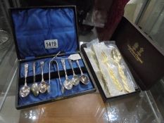 A cased set of EPNS teaspoons with sugar tongs and an Arthur Price knife, fork and spoon.
