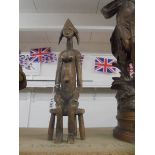 A carved trible fertility figure. 42cm high