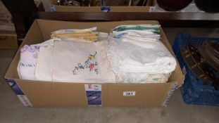 A box of linens and doilies etc