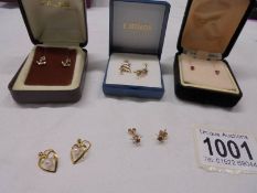 A pair of 9ct gold anchor earrings, a pair of ruby earrings and three other pairs of earrings.