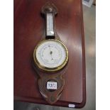 An oak barometer/thermometer.